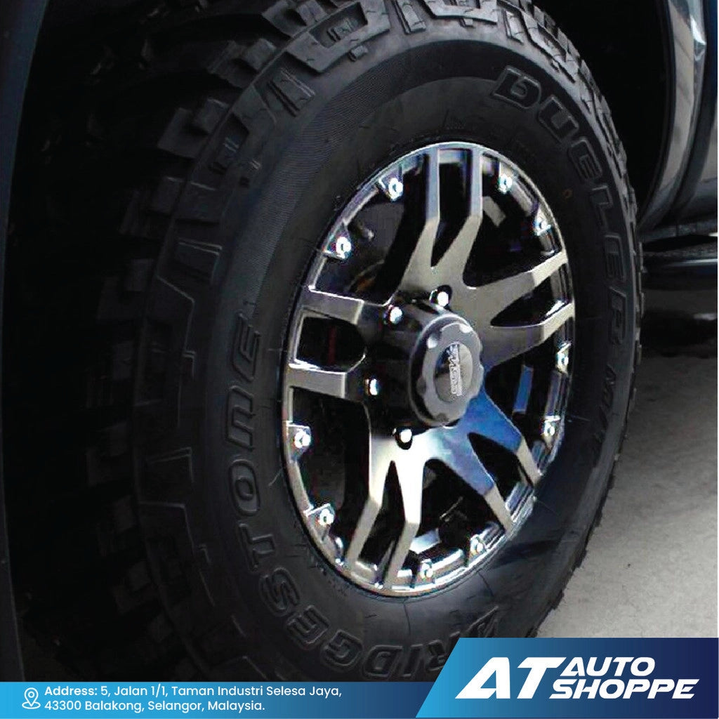 Close-up of a tire with a chrome rim, featuring the Goodyear brand, on a dark background.