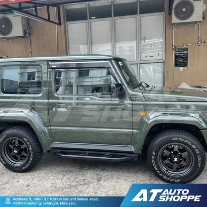 Green SUV parked in front of a building with 'AT Auto Shoppe' branding.