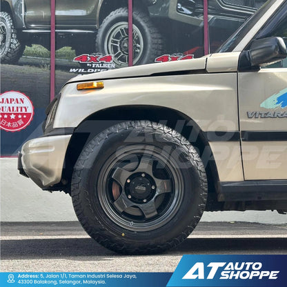 Beige SUV with black wheels and tires, parked on a street with 'AT Auto Shoppe' branding.
