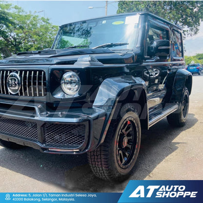 Black luxury SUV on a road with 'AT Auto Shoppe' branding.