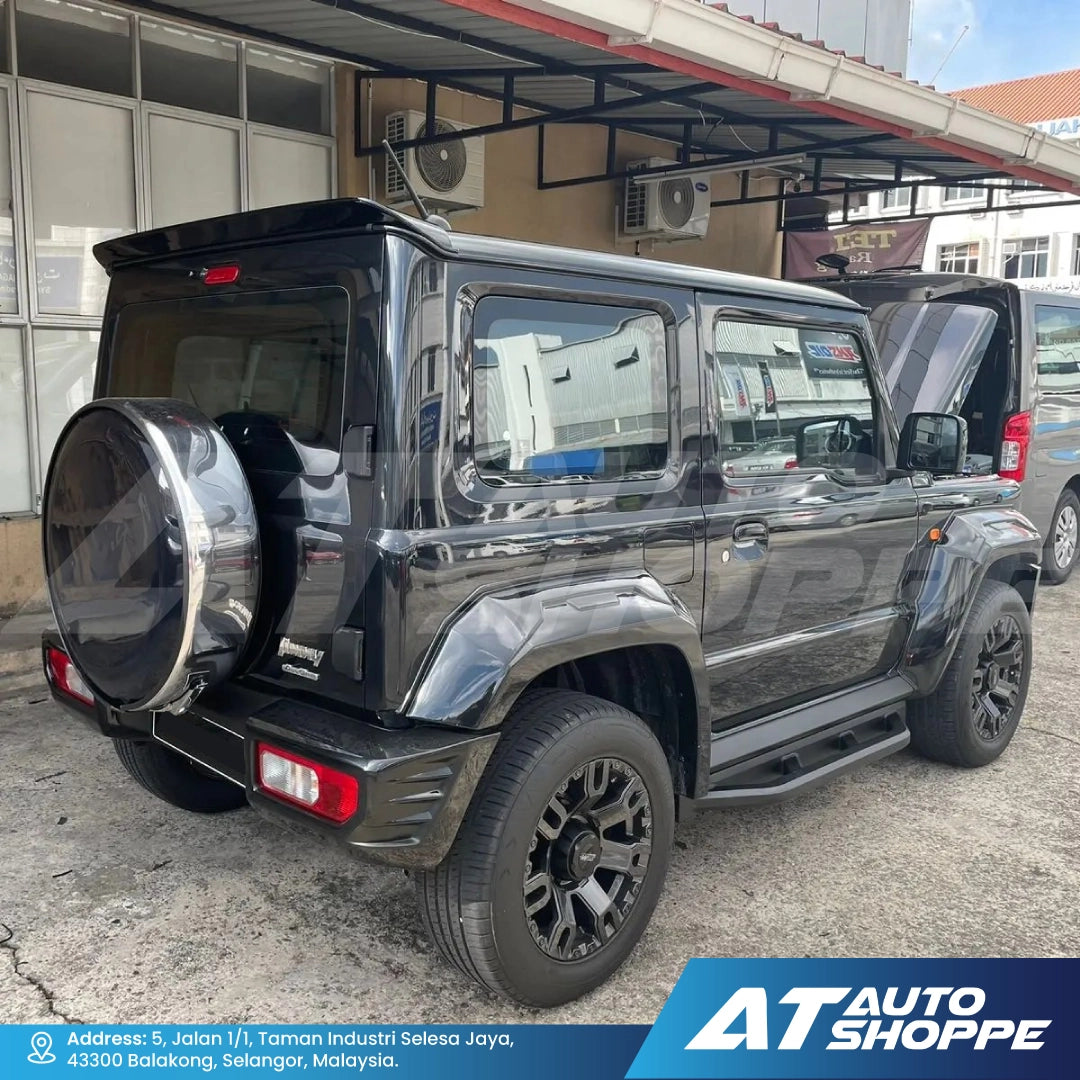 Black SUV parked outside a building with 'AT Auto Shoppe' branding.