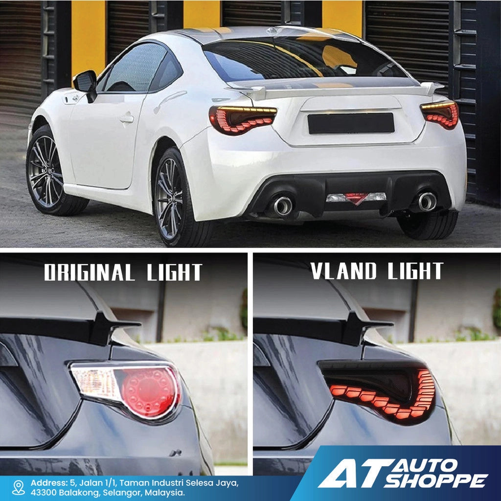 White car with a comparison of original and Vland lights at AT Auto Shoppe.