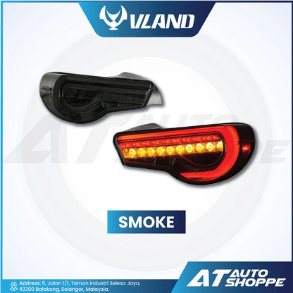 Smoke-colored car tail light with Vland and AT Auto Shoppe branding on a white background.