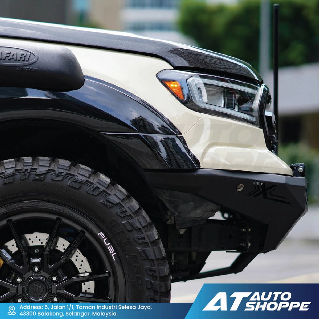 Close-up of a black and beige truck with AT Auto Shoppe branding.