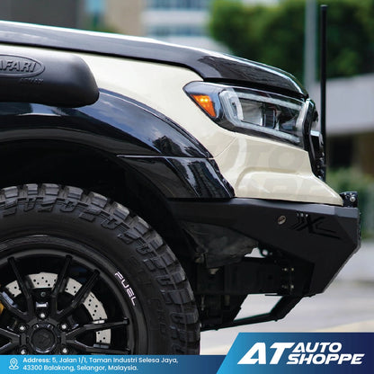 Close-up of a black and beige truck with AT Auto Shoppe branding.