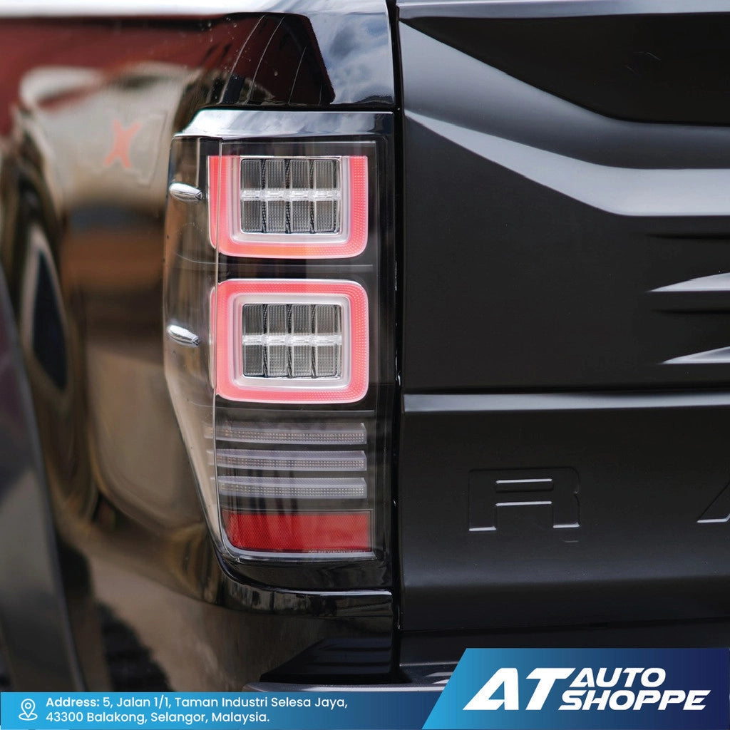 Close-up of a Vland taillight with 'AT Auto Shoppe' branding.
