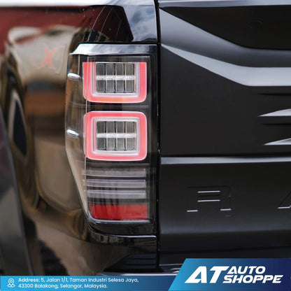 Close-up of a Vland taillight with 'AT Auto Shoppe' branding.