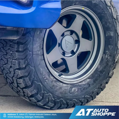 Close-up of a tire with a VLF rim on a vehicle, featuring the AT Auto Shoppe logo.