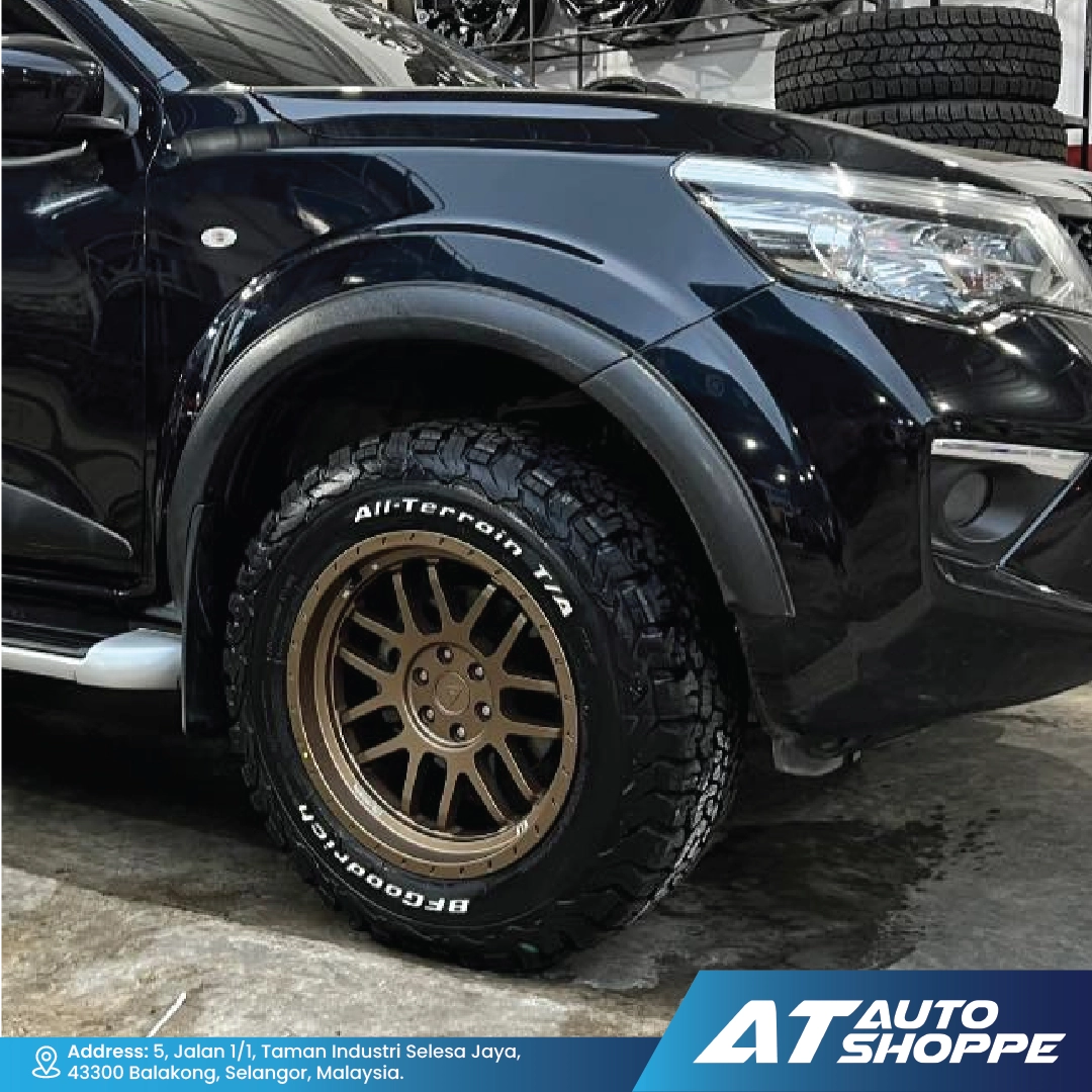 Black SUV with VLF bronze wheels in a garage setting, featuring AT Auto Shoppe branding.