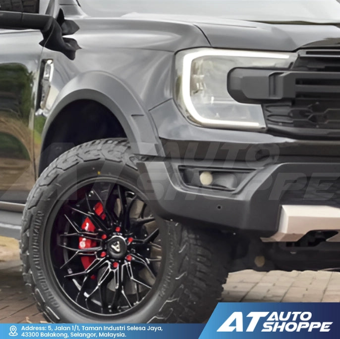 Close-up of a gray truck with a Vampire  black wheel and red accents, featuring the AT Auto Shoppe logo.