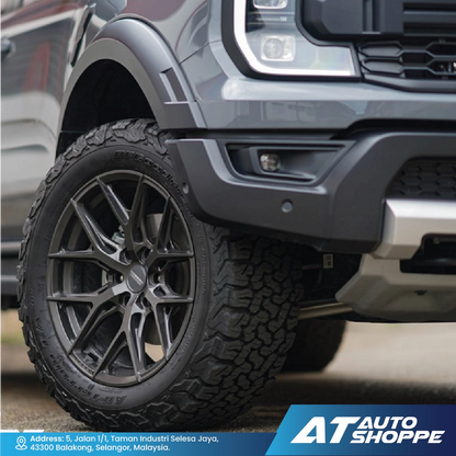 Close-up of a truck tire with AT Auto Shoppe branding.
