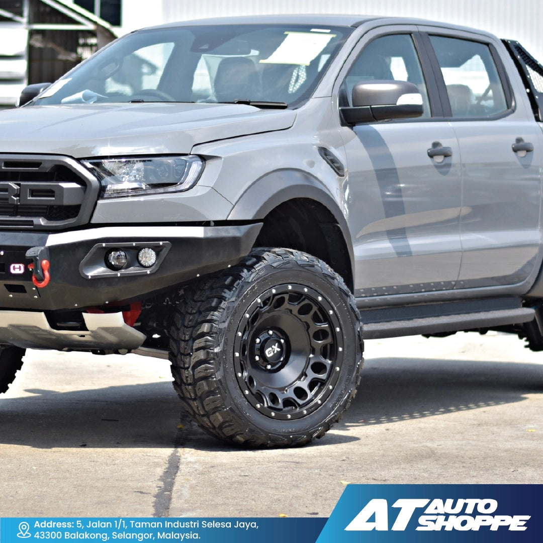 Gray Ford Ranger truck with off-road tires and black XD rims on a paved surface, featuring AT Auto Shoppe branding.