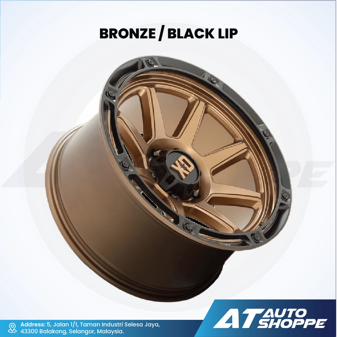 XD bronze alloy wheel with black lip on a white background, featuring AT Auto Shoppe branding.